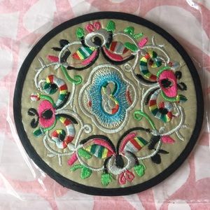 A pair of embroidered coasters